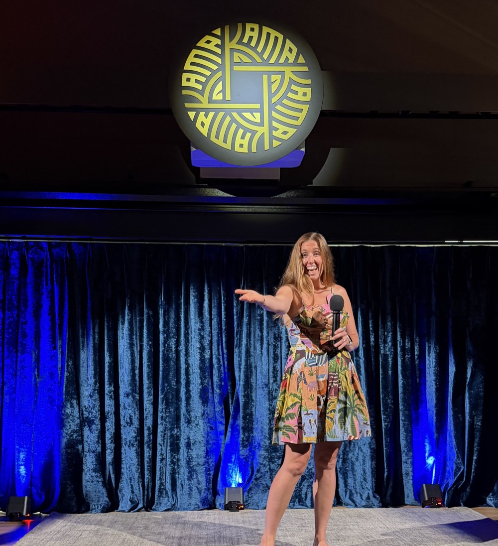 Jenn on stage with a microphone